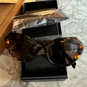 Authentic Prada women’s 53mm sunglasses.  In color honey tortoise